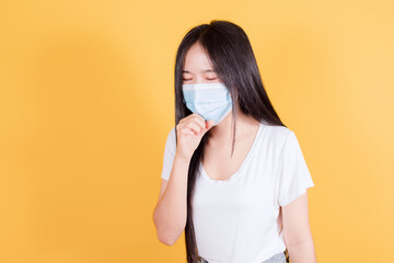 Asian woman has sore throat on yellow background