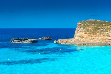 Fototapeta na wymiar Amazing crystal clear water in the Blue Lagoon of Comino Island, Malta