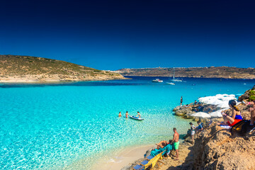 Comino, Malta, 22 May 2022:  Tourists enjoying the crystal clear water of the Blue Lagoon