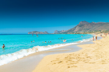 Falassarna, Greece, 13 June 2022:  Tourists on the sandy beach of Falassarna in Crete Island