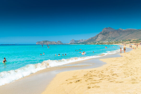 Falassarna, Greece, 13 June 2022:  Tourists on the sandy beach of Falassarna in Crete Island