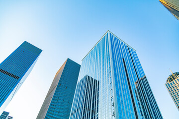 Urban skyscrapers under blue skies