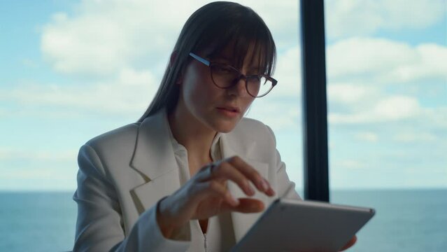 Focused ceo working tablet in suit closeup. Successful woman surfing online