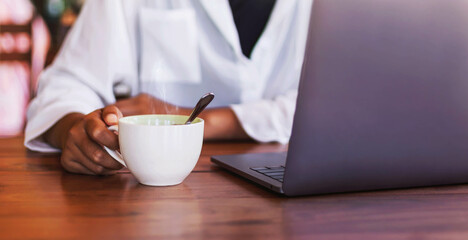 The hot coffee mug on the desk is a little smoky.