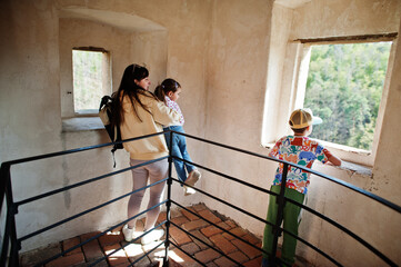 Mother with kids looking from tower in Veveri castle, Czech Republic.