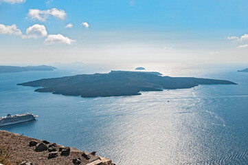 view of an island in the sea with ship in Santorin