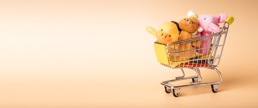 Childish Mini Shopping Trolley Cart Full Of Soft Plush Toys For Kids On Banner With Copy Space For Ad Text. High Quality Photo