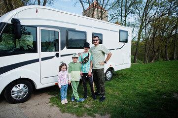 Father with three children travel at motorhome RV camper van.
