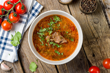 soup kharcho with meat on bowl top view on wooden table