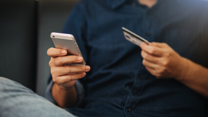 A man with mobile smartphone in hand paying online shopping. Online transaction banking and digital marketing technology concept.