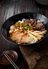 Close-up of Chinese Guilin rice noodles on a dark wooden table