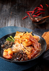 Close-up snail rice noodles on a dark wooden table