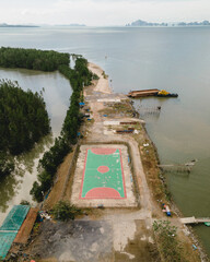 Aerial view of a football field in the mangrove jungle