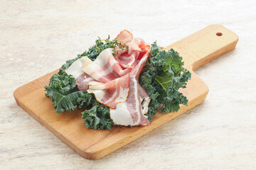 Raw pork bacon over board
