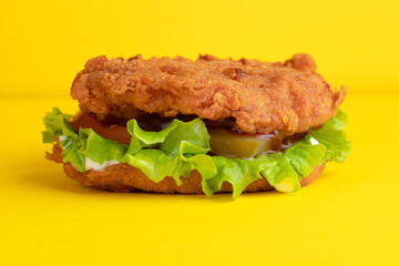 Burger with chicken, on a yellow background, bright background
