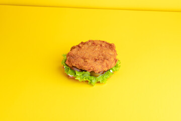 Burger with chicken, on a yellow background, bright background