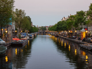 Fototapeta na wymiar Sunset in Amsterdam at the river and bridge