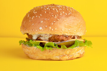 Burger with chicken, on a yellow background, bright background