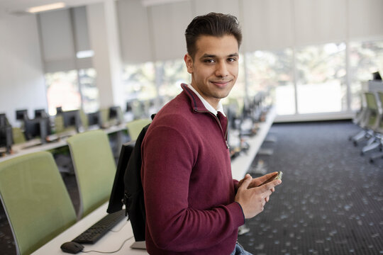 Portrait Smiling Handsome Young Male College Student In Computer Lab