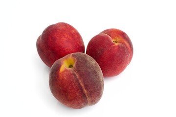 three fresh and ripe red peaches