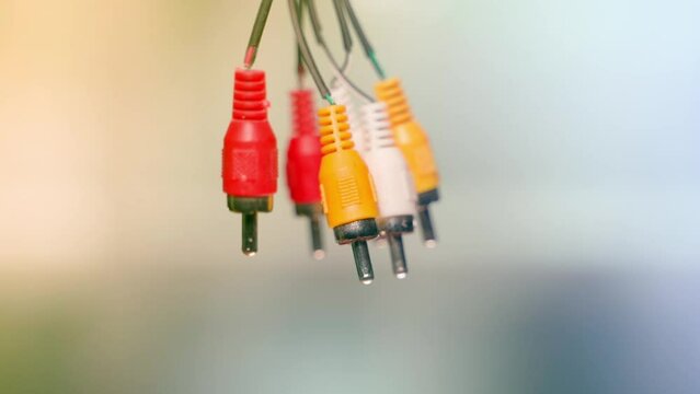 worn old low-quality RCA connector tulips close-up on a blurred background