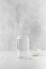 A glass of water and a bowl with collagen powder. Skin care, rejuvenation.