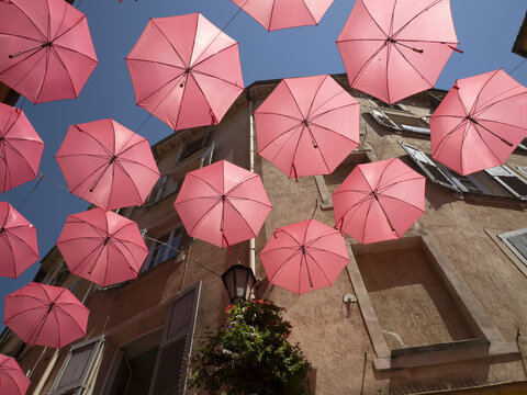 Fototapeta Grasse France pink umbrellas street