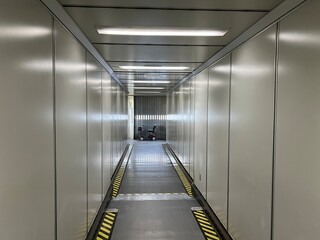 Electric powered wheel chair, for airline passengers with mobility challenges, parked at the end of...