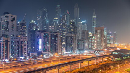 Obraz na płótnie Canvas Dubai marina tallest block of skyscrapers night timelapse.