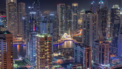 Dubai Marina skyline with Mohammad Bin Ahmed Al Mulla mosque aerial timelapse at night.
