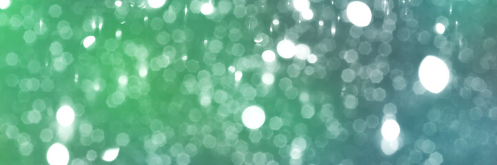 Summer green and blue sparkling glitter bokeh background, banner texture. Abstract defocused lights header. Wide screen wallpaper. Panoramic web banner with copy space for design