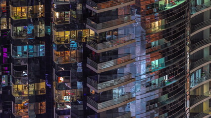 Fototapeta na wymiar Night view of glowing windows in apartment tower timelapse.