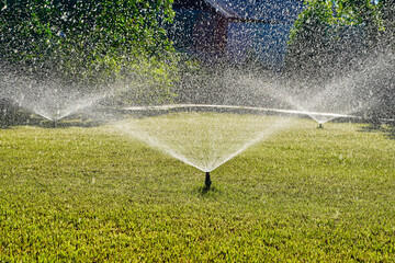 Automatic Garden Sprinkler. Backyard Watering Technology for green lawn - obrazy, fototapety, plakaty