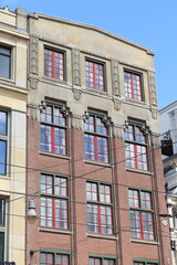 Fototapeta na wymiar Amsterdam Leidsestraat Street Art Deco Building Exterior with Green and Red Window Frames, Netherlands