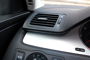 Obraz na płótnie Canvas Car air vents close-up grille. Air ventilation grille with power regulator. Modern Car air conditioner, interior of a new modern car.
