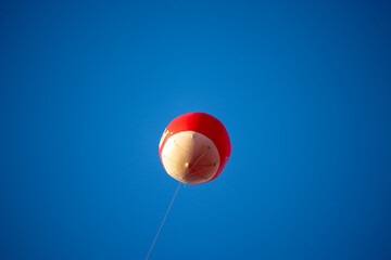 Red balloon in the blue sky.