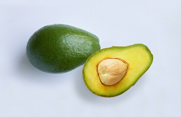 Avocado fruit and avocado cut in half on white background.                             