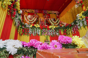 Idol of God Jagannath, Balaram and Suvodra is being worshipped. Ratha jatra festival at Howrah, West Bengal, India. Low angle shot.