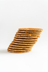 A stack of Dutch syrup waffle cookies ( stroopwafels) at an angle on white
