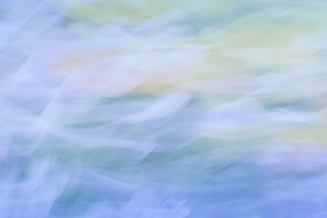 Abstract long exposure image in soft pastel colours taken outdoors in summer.