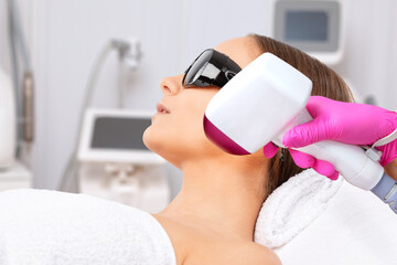 Elos epilation hair removal procedure on a woman’s body. Beautician doing laser rejuvenation in a...