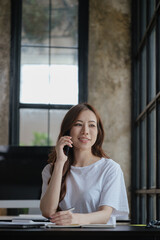 Young business woman discussing and talking work via smartphone with happy face.