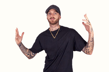 tattooed rap singer posing in studio wearing black clothes