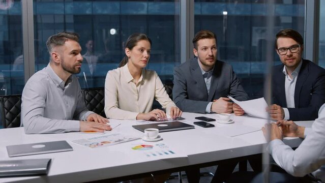 Young businessman talking about himself at job interview in modern office