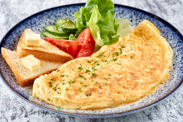 omelet with fresh vegetables and toasts