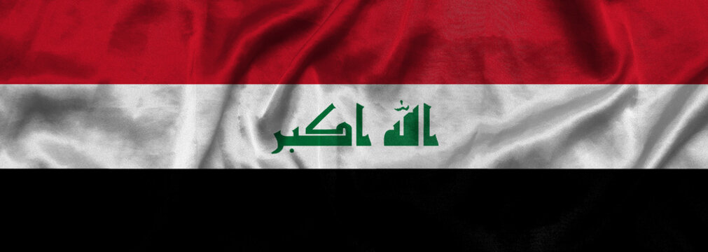 Elongated national flag of Iraq with a fabric texture fluttering in the wind. Iraqi flag for website design. 3d illustration
