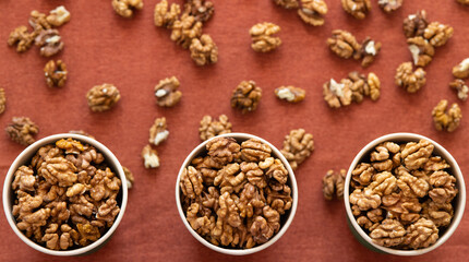 Nuts on a wooden table. Walnut border.