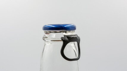 Bottle neck with ring pull cap for opening closeup