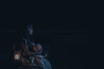 Obraz na płótnie Canvas sad child ghost at night,Halloween Festival concept,Friday 13th,Horror movie scene,A girl with doll