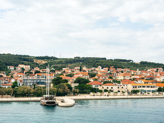 Obraz premium Waterfront view with boat and houses in Supetar, Brac Island Croatia